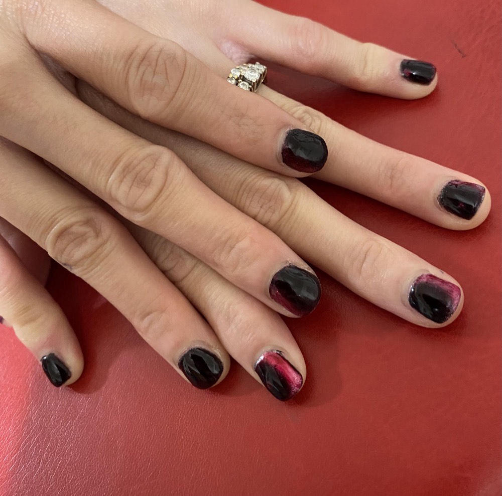 A manicure finished in glossy dark polish